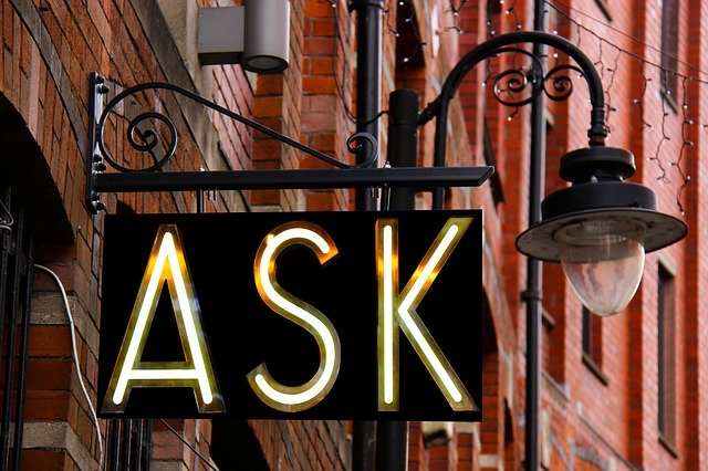 A neon sign that says "ASK"